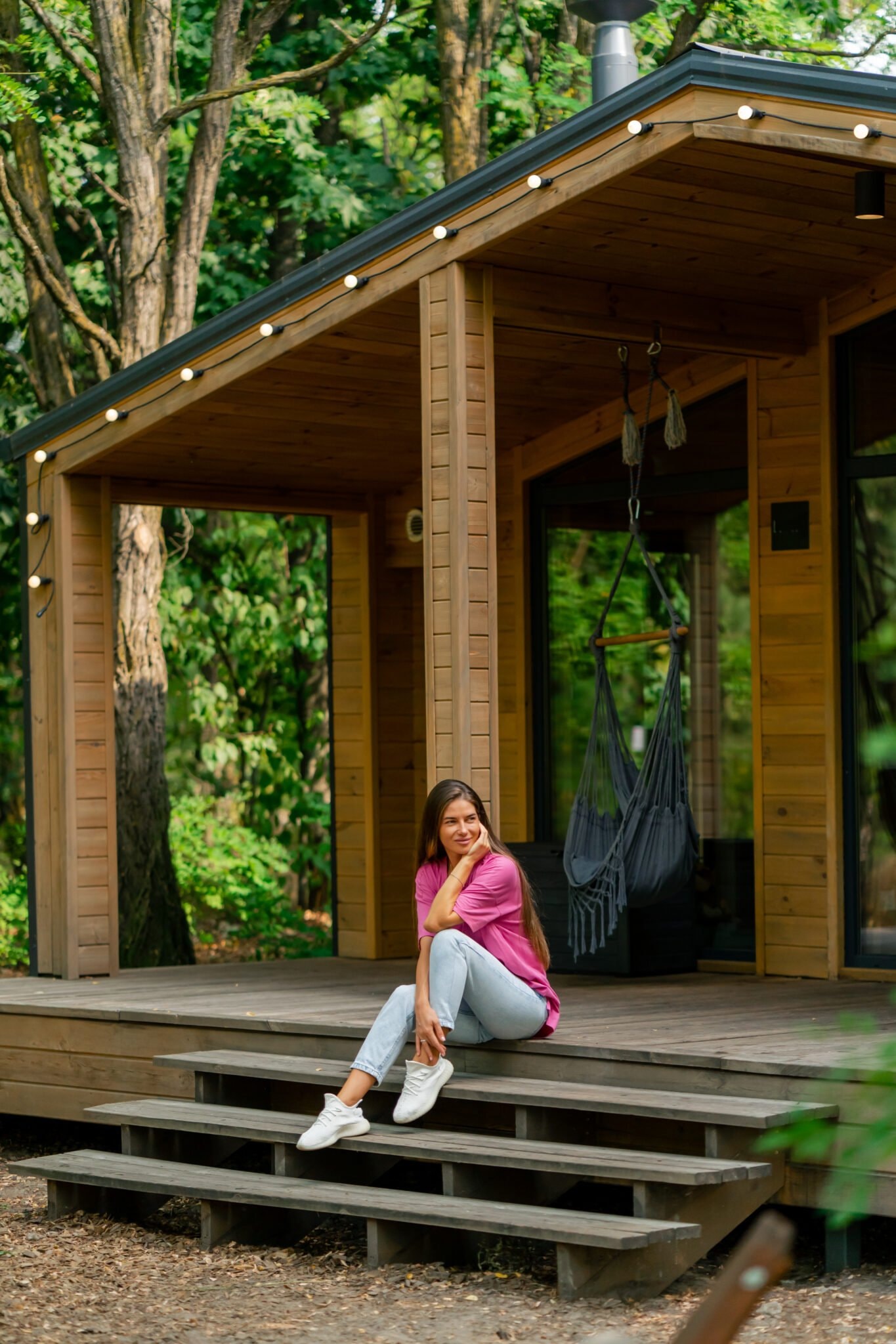 Woman relaxing on garden room terrace