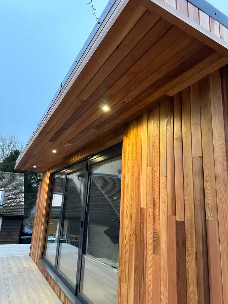 Modern wooden garden room exterior with glass doors